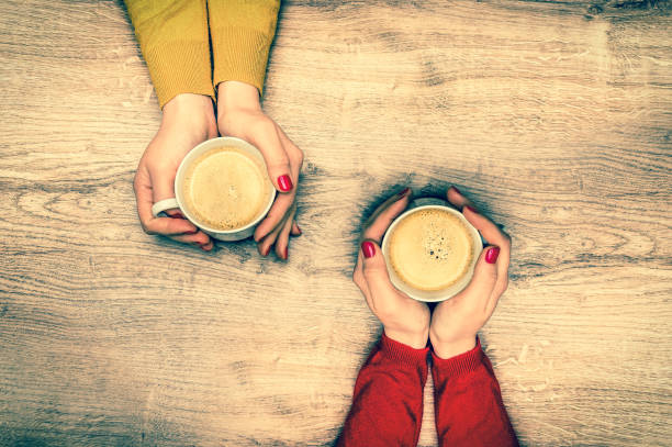 istock Female hands holding a cup of hot coffee 697928950