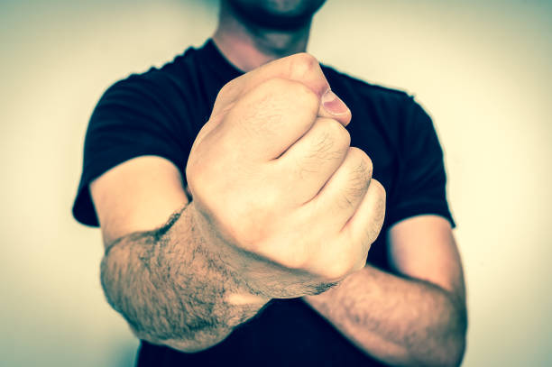 Young boxer showing punch a fist - martial arts concept