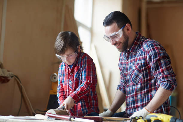 istock Woodcarving with father 697940032