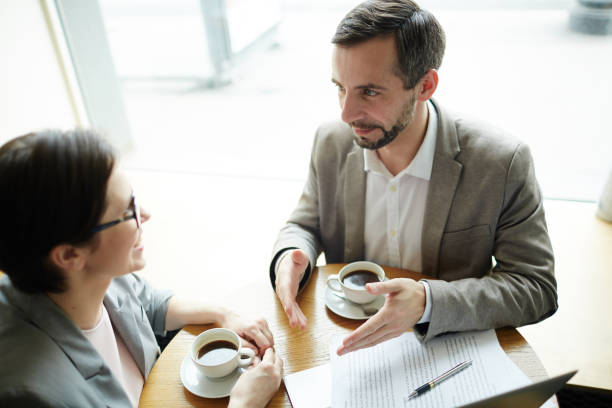 istock Mature Businessman Explaining Ideas at Work Meeting 697940602