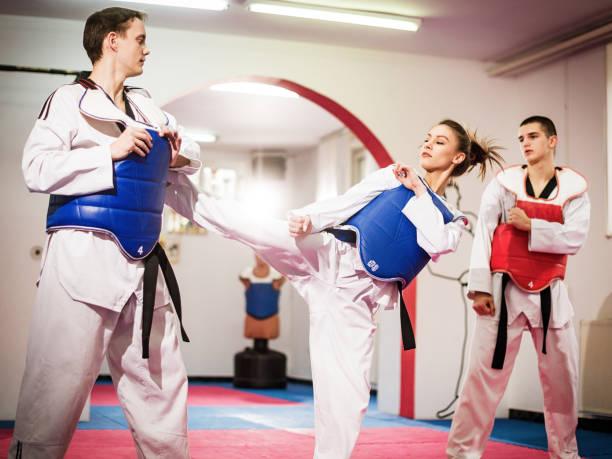 istock Female champion in taekwondo kicking on training 697945778
