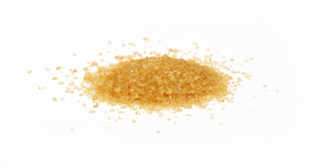 istock Pinch of brown cane sugar spilled on white 697945792