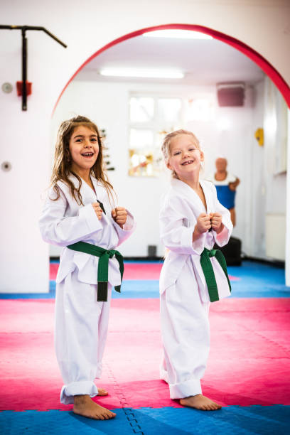 istock Successful girls exercising and warming up for taekwondo 697945994