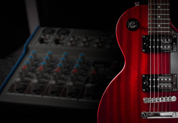 istock Red electric guitar and classic amplifier on a dark background 697946636