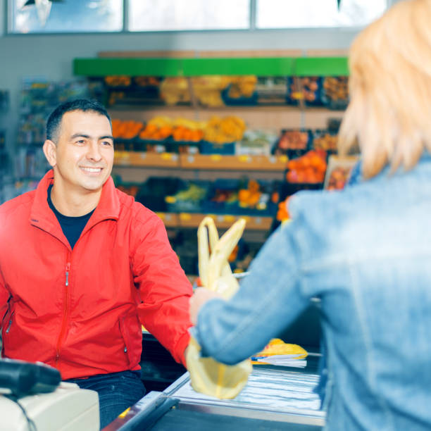 istock Woman paying for groceries 697946984