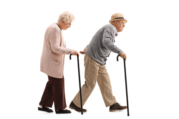 istock Elderly man and an elderly woman with canes walking 697949798