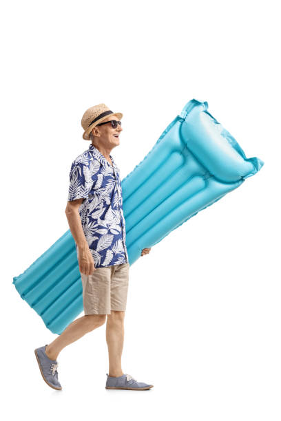 istock Senior with an air mattress walking 697950376