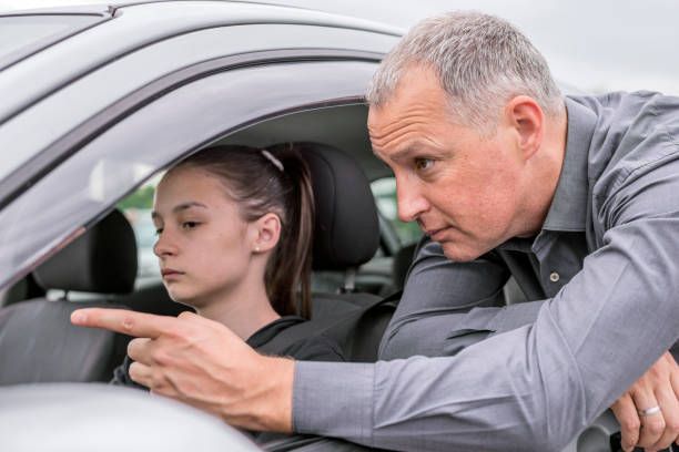 istock Young Woman Having Driving Lesson With Instructor 697954718