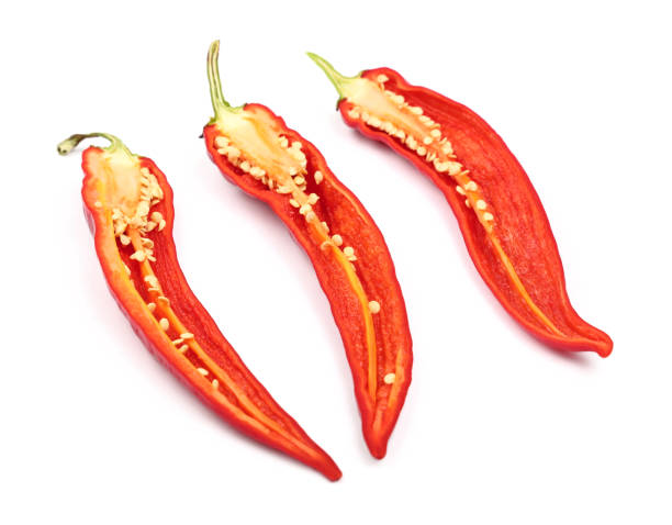 istock Three cut hot chili peppers isolated on white 697954784