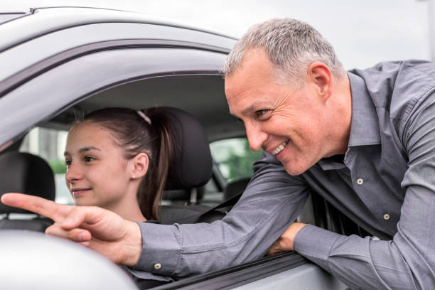 istock Teenager with father learning to drive 697956914