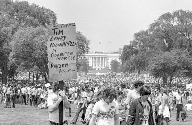 Free Tim Leary! A protester carries a hand made sign reading "Free Tim Leary! Kidnapped by government officials."  100,000 demonstrators converged in Washington, DC, on May 9, 1970 to protest the fatal shootings at Kent State University and the American military incursion into Cambodia. peace demonstration stock pictures, royalty-free photos & images