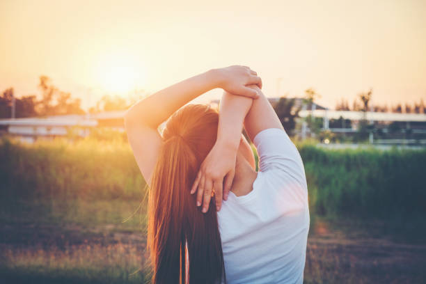 Women exercising in sunny bright light.in park