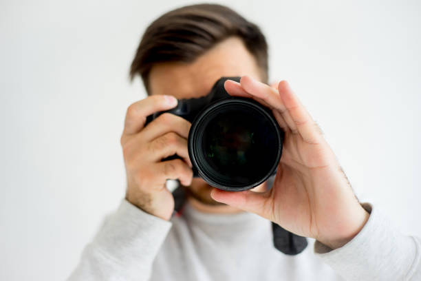 istock Male photographer with camera 697959294