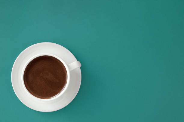 istock Coffee in white cup on green background. 697959392