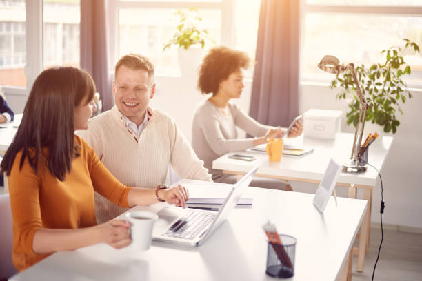 istock Young happy people discussing business issues 697960166
