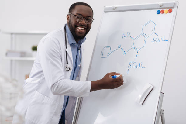 istock Delighted smart man studying organic chemistry 697961206