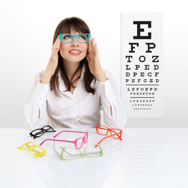 smile female face chooses spectacles on eyesight test chart background, eye examination ophthalmology concept