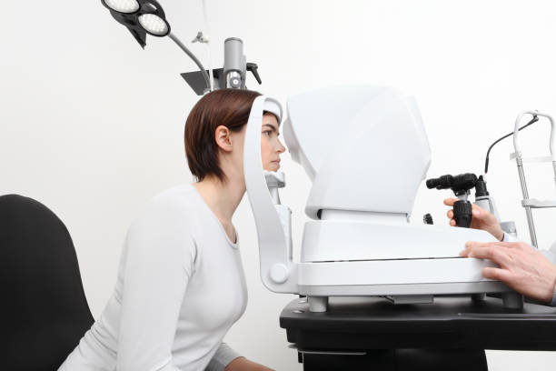 istock woman doing eyesight measurement with optician slit lamp 697961764
