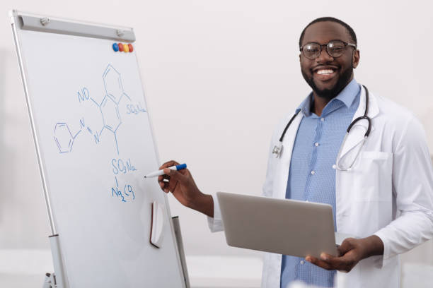 istock Cheerful positive scientist holding a laptop 697963174