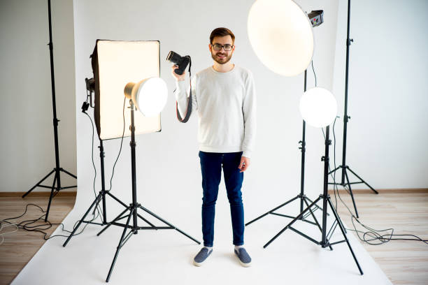istock Young male photographer in studio 697963972