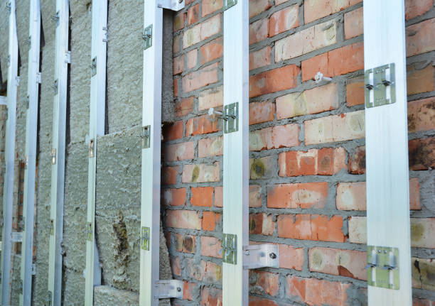istock Insulating Construction. House brick wall insulation for energy saving. Renovation and insulation residential house. Insulation house. 697964376