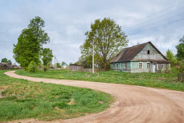 istock A dirt road with a green house in the summer 697965342