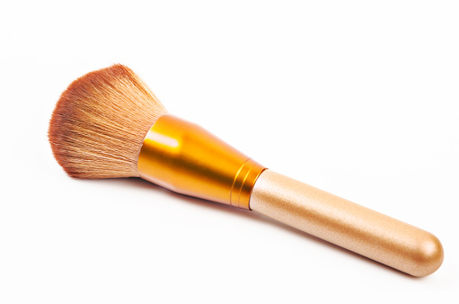 Makeup gold brush powder Blusher on white background.
