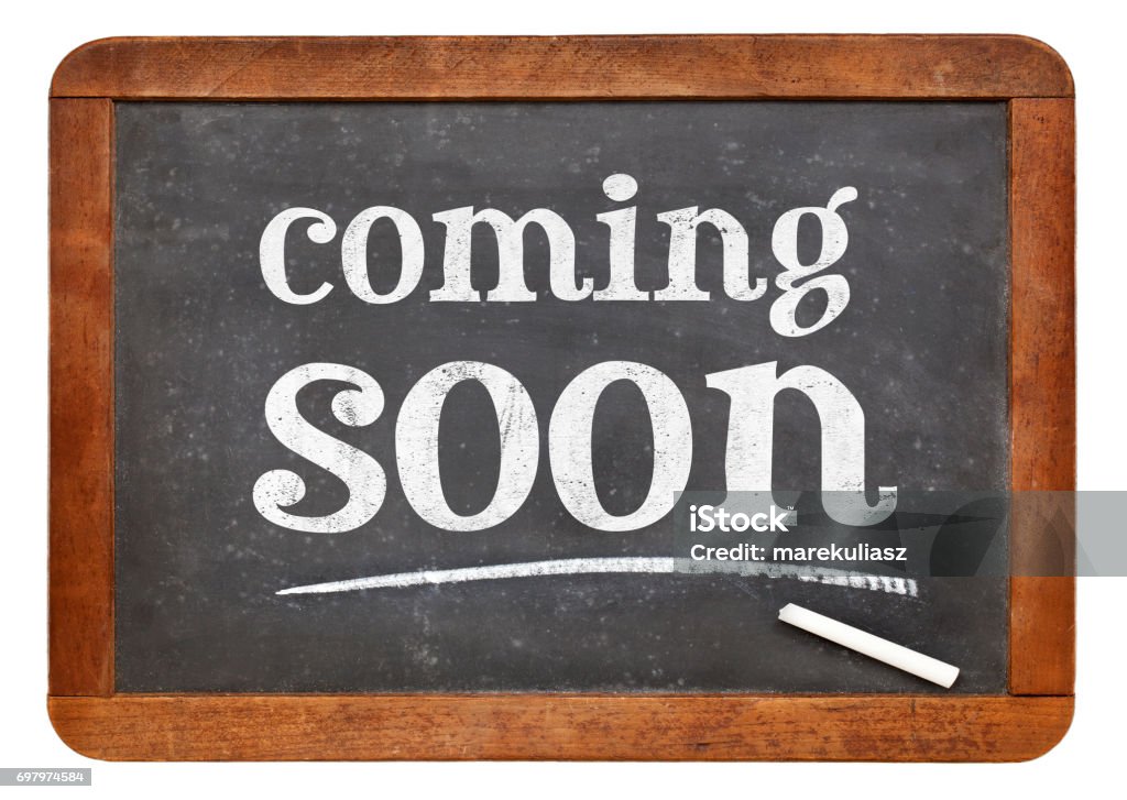 coming soon blackboard sign coming soon sign - white chalk text on a vintage slate blackboard Advertisement Stock Photo