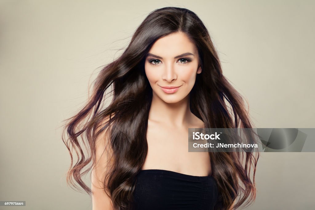 Young Hispanic Fashion Model Woman with Brown Blowing Hair and Perfect Makeup Wind Stock Photo