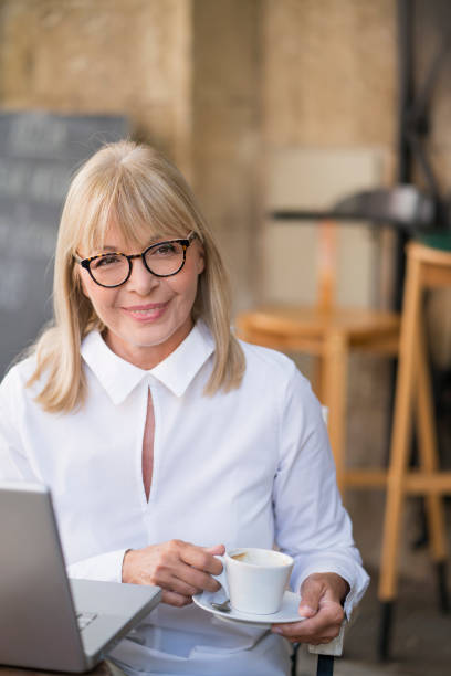 istock Mature woman working at cafe 697979402