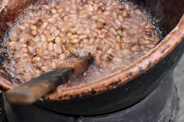 Peanuts in a pan with bowling sugar