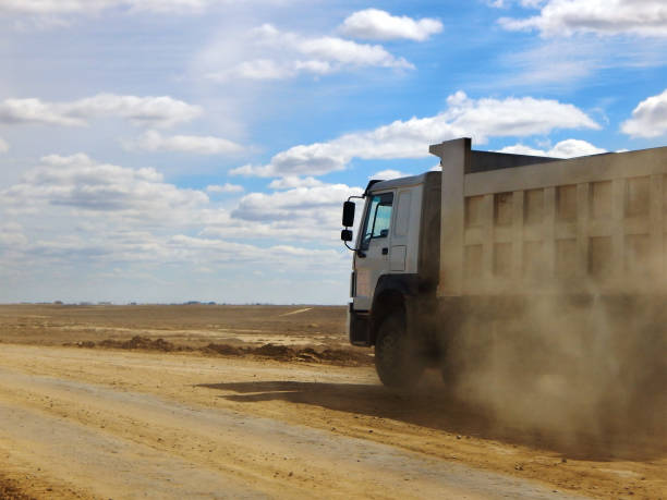istock Dump truck on a dirt road. 697982944