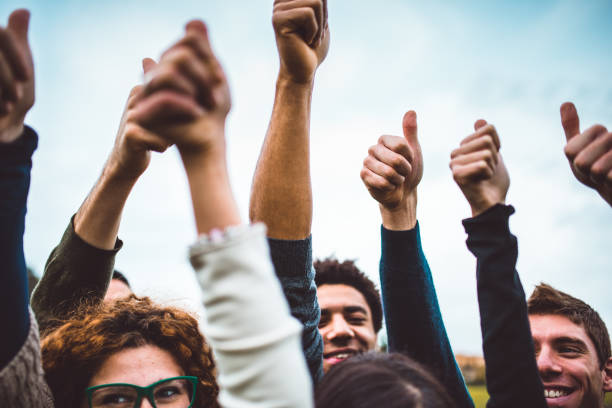 istock happiness friends thumbs up for victory 697986390