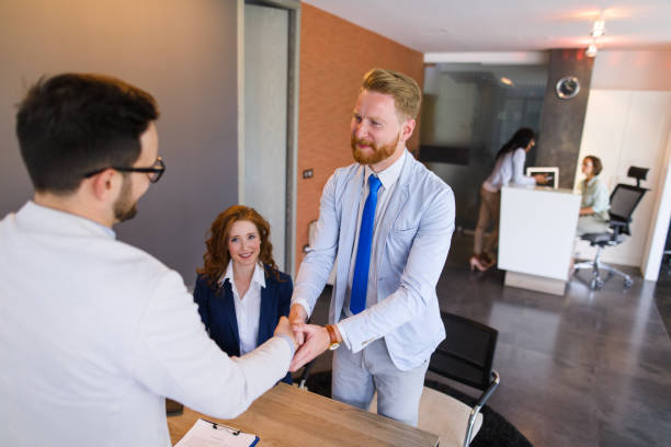 istock Couple talking to loan officer and shaking hands 697992170