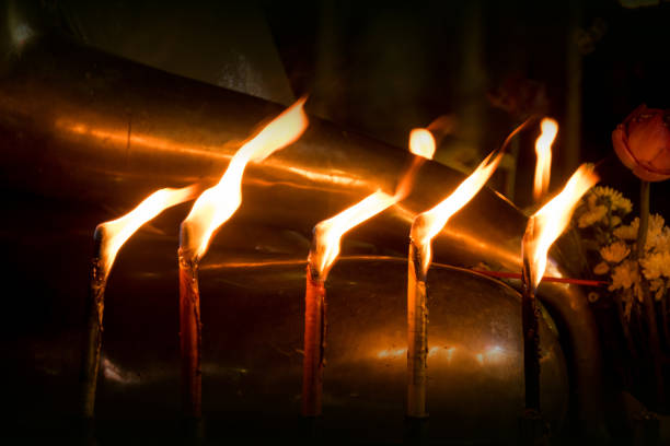 Candle and light on the front Buddha statue in night time