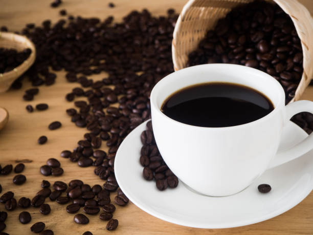 istock coffee cup and coffee beans in basket weave on wood table 697997034