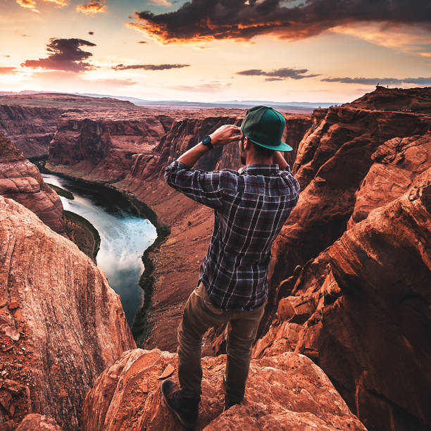 istock man living on the edge at the horseshoe bend 697997130