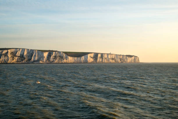 Cross channel ferry departs Dover, UK Early morning spring sunshine as a cross channel ferry passes the white cliffs of Dover, Kent, UK heading for Calais, France ferry dover england calais france uk stock pictures, royalty-free photos & images