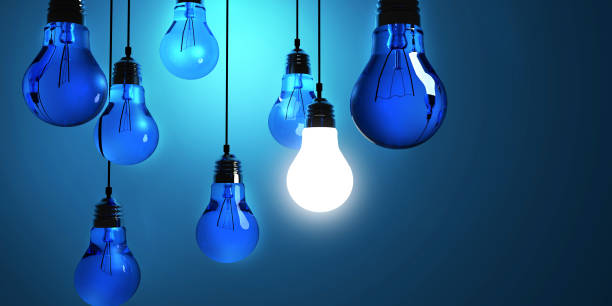istock Idea concept, Hanging light bulbs with glowing one isolated on dark blue background.3d rendering 697998214