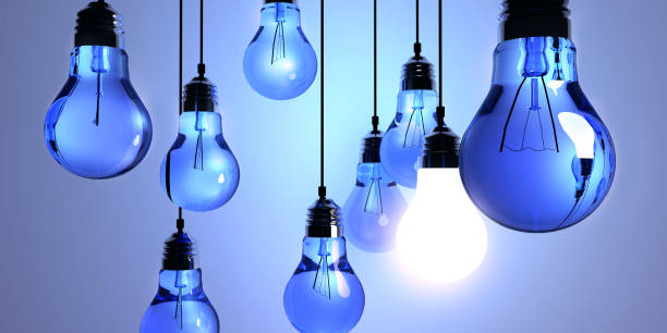 istock Idea concept, Hanging light bulbs with glowing one isolated on dark blue background.3d rendering 697998236