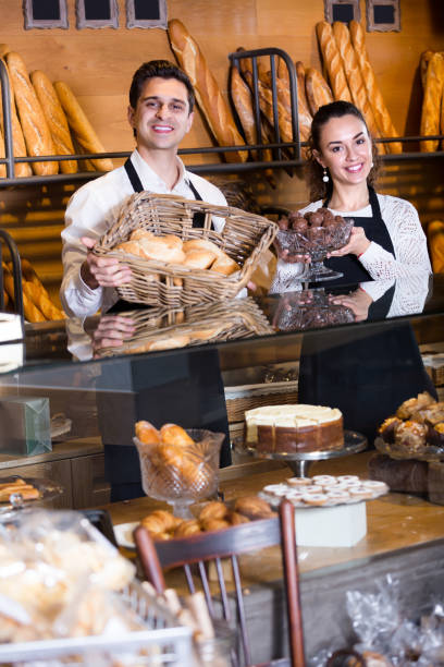 istock Man and woman bakers in bakery 697998494