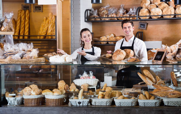 istock Portrait of charming  couple at bakery display with pastry 697998518