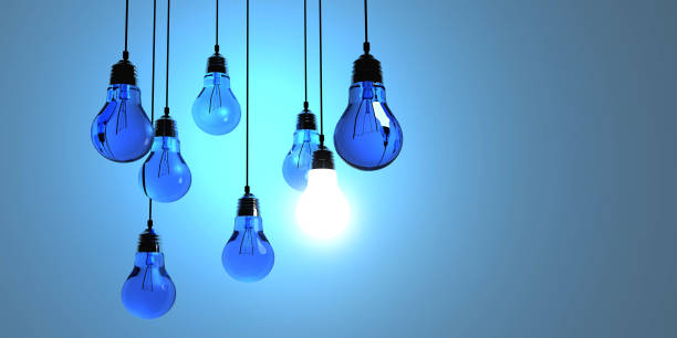 istock Idea concept, Hanging light bulbs with glowing one isolated on dark blue background.3d rendering 697998626