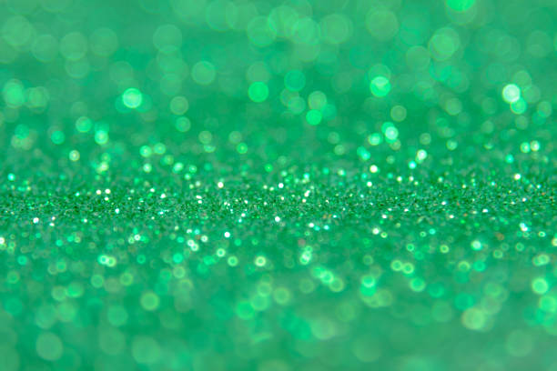 istock Green glitter abstract background with bokeh defocused lights 698001978