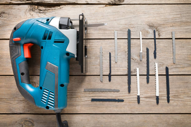 istock Electric jigsaw with blades on wooden table 698002340