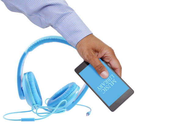 Headphones hand holding cell phone with music library on display screen isolated on white background
