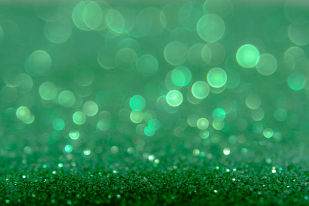 istock Green glitter abstract background with bokeh defocused lights 698004978