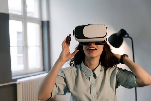 istock Young woman using Virtual Reality Glasses. Virtual reality mask. VR. 698005220
