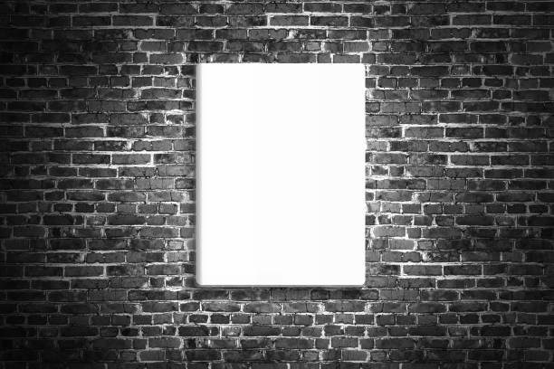 istock Blank poster hanging on brick black wall of broken painted brick, mock up 698005278