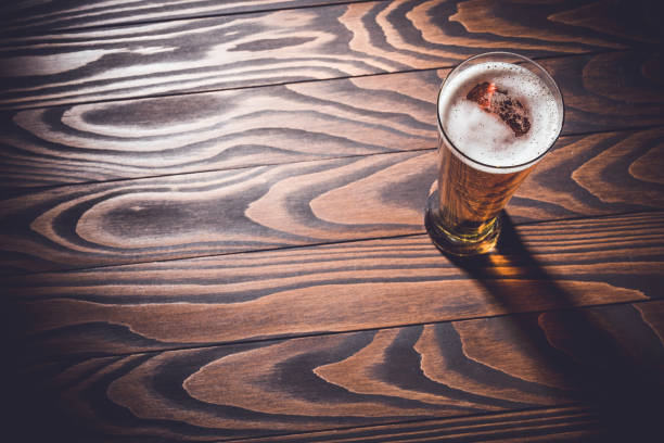 istock Beer glass on an old dark wooden table. 698006280